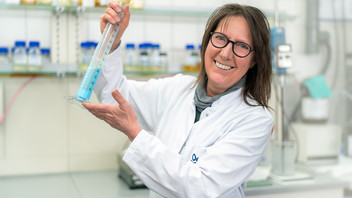 Laboratory worker holds test tube