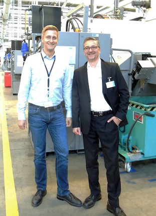 Two men in a production hall