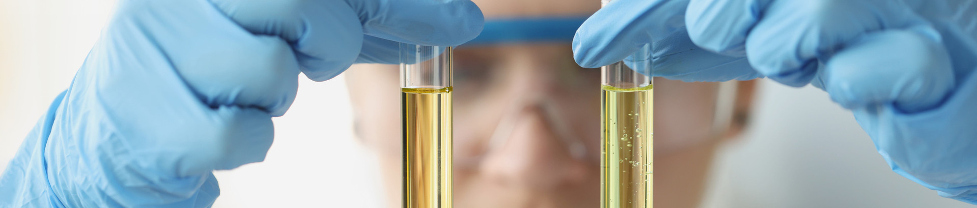 Woman holds two pipettes in her fingers