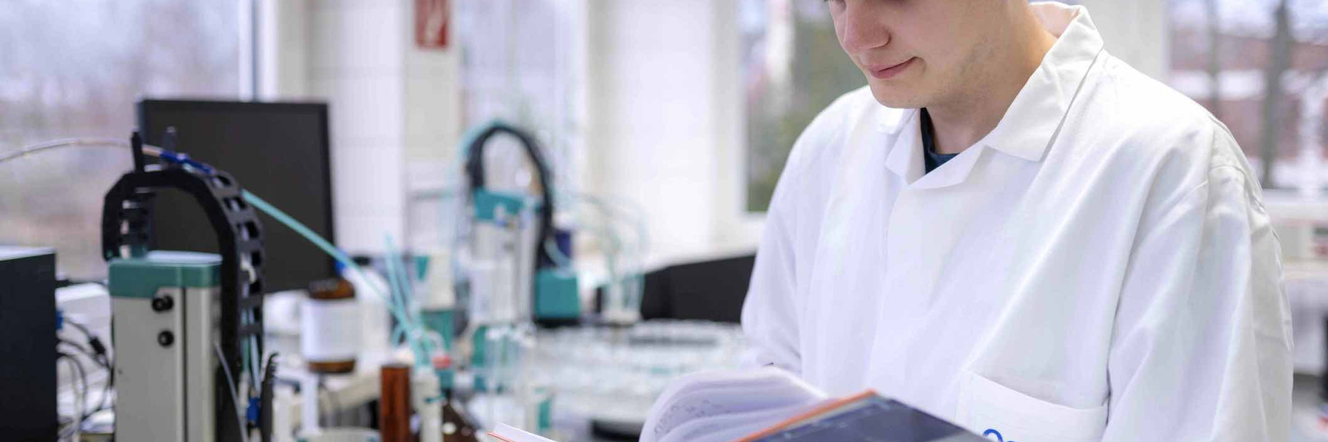 Man in the lab leafs through a folder