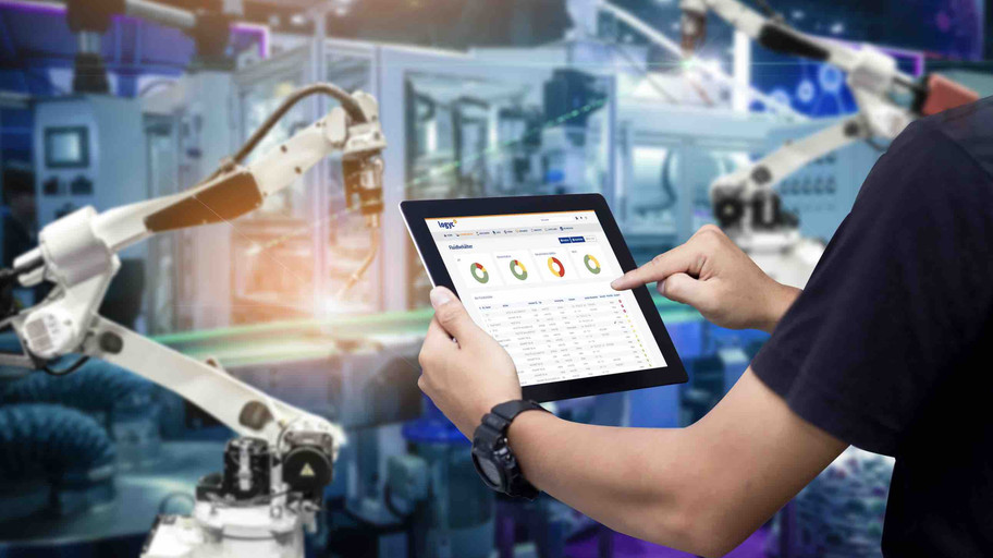 Man monitors cooling lubricants with tablet in hand Man monitors cooling lubricants with tablet in hand