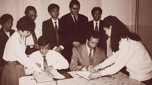 Group of Asian people in a room at a table