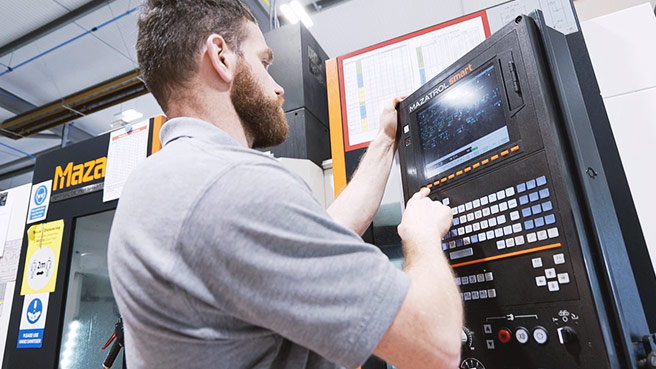 A CWM employee operates a Mazak machine